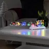 Tischdeko Schneemann mit Hundeschlitten bunte LEDs