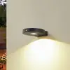 Lucande LED-Solar-Wandlampe Tavon, rund, schwarz, Sensor