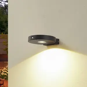 Lucande LED-Solar-Wandlampe Tavon, rund, schwarz, Sensor