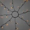 Bild von Konstsmide - LED Baummantel mit Ring, 8 Stränge à 30 Dioden, vormontiert, mit Glimmereffekt, 240 bernsteinfarbene Dioden (120 glimmend), 24V Außentrafo, schwarzes Kabel - 6320-810
